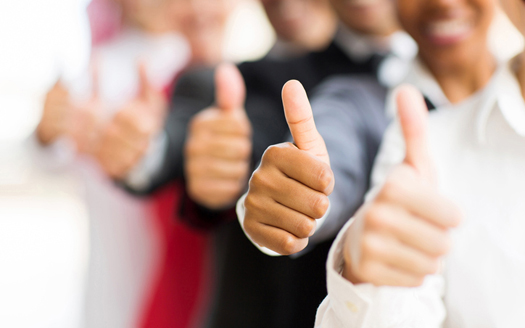 closeup portrait of business people giving thumbs up