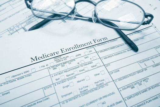 Medicare enrollment form and glasses