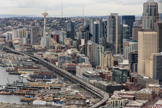 Aerial view of downtown Seattle looking north up the Alaskan Way viaduct and Seattle waterfront, with the Space Needle in the distance