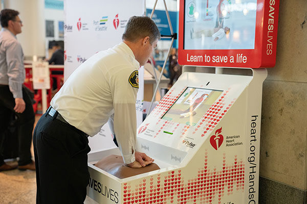 Port of Seattle Fire Chief Randy Krause demonstrated how to use the interactive Hands-Only CPR kiosk at Sea-Tac Airport.