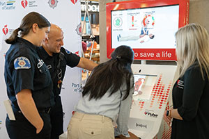 Port of Seattle Fire Department personnel were among those who celebrated unveiling of the new Hands-Only CPR kiosk at Sea-Tac Airport.
