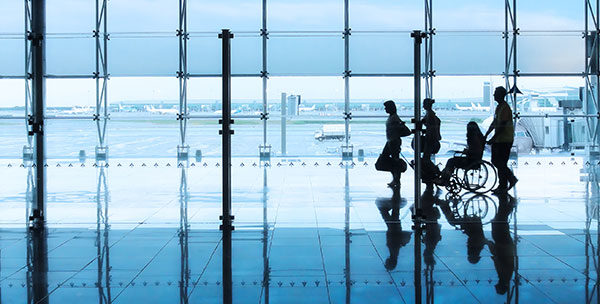 people walking through an airport