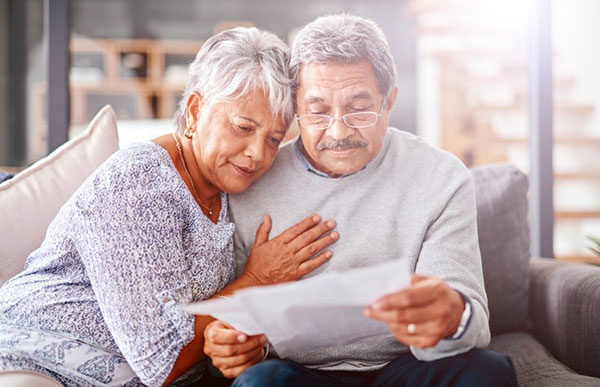 two elderly people reviewing documents