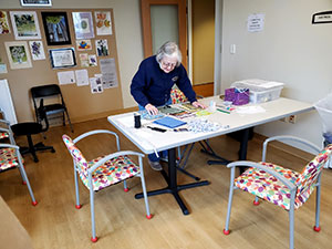 Skyline resident Mary Whitmore sorts through patterned fabrics that will become face masks.