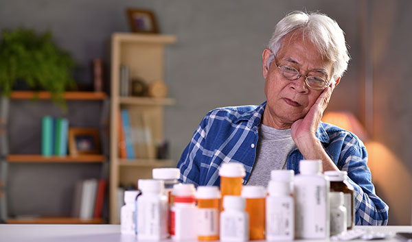elderly woman going through her medications