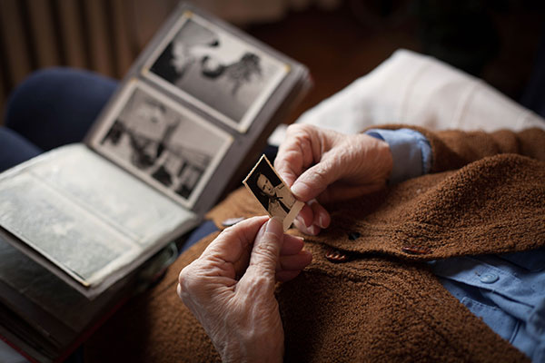 elderly person looking at familiy photos