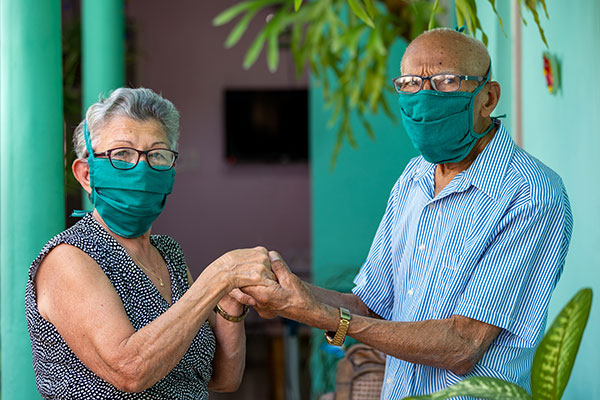 a couple wearing masks while holding hands
