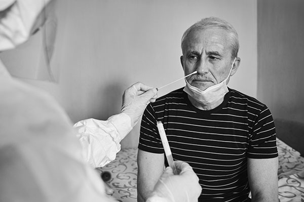 elderly man receiving a COVID test