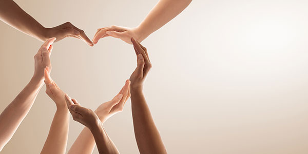 group of hands making a heart shape