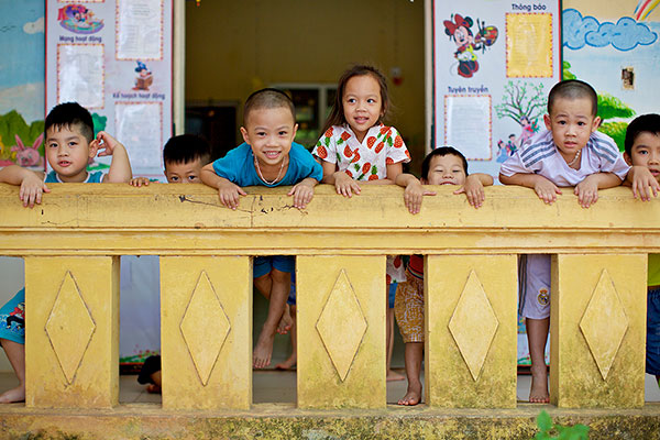 young children looking over a railing