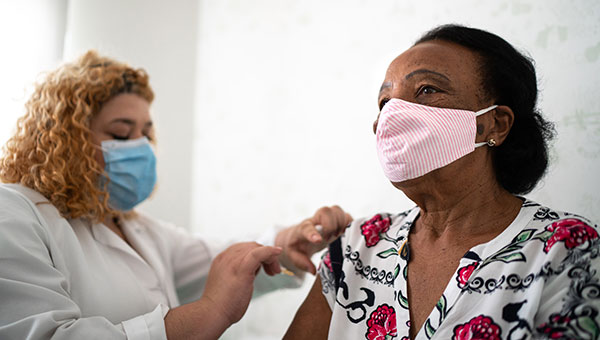 woman receiving her vaccine