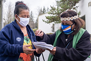 Jiji Jally (right) and Bokai Mokin check in after Mokin received a COVID-19 vaccination at a recent clinic for Pacific Islanders in Federal Way.
