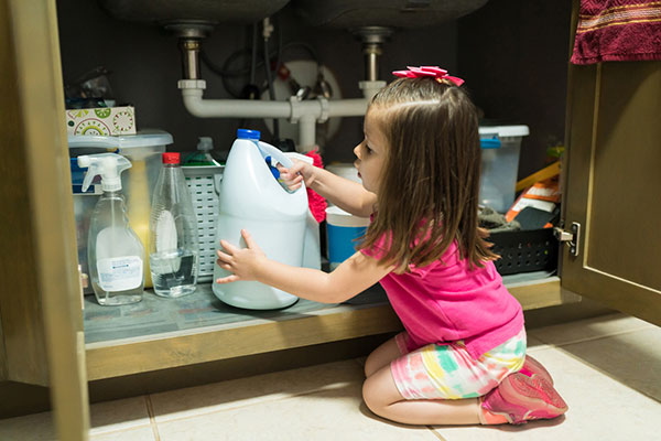 YOung girl getting into household chemicals