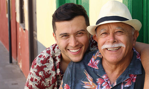 father and son smiling at the camera