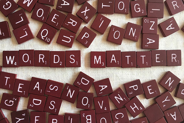 Scrabble letters spelled out to say 'Words Matter'