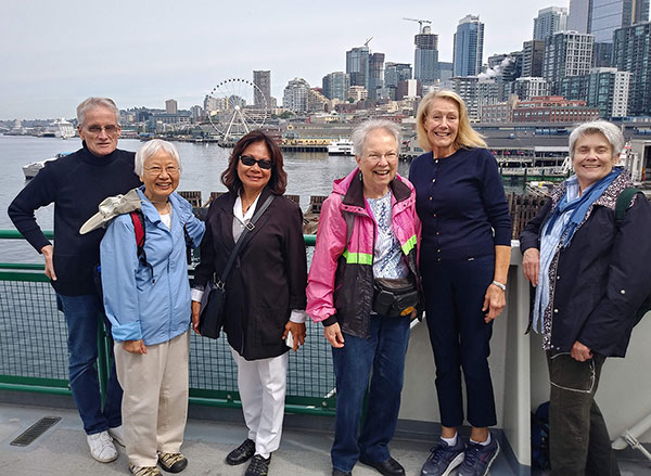 staff and residents from Greenwood Senior Center with Seattle skyline in the background