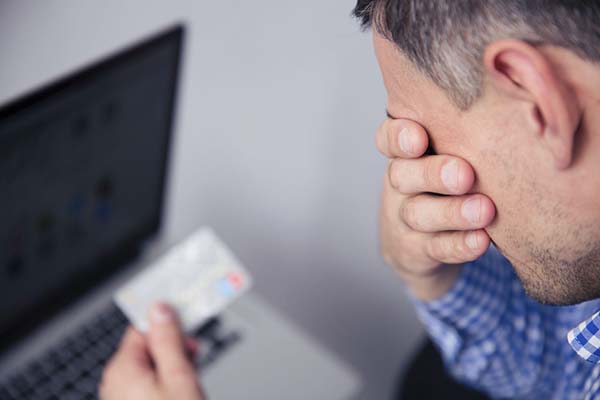 man stressed out by credit card fraud