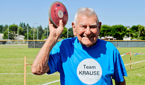 Leonard Krause holding shotput at Senior Games