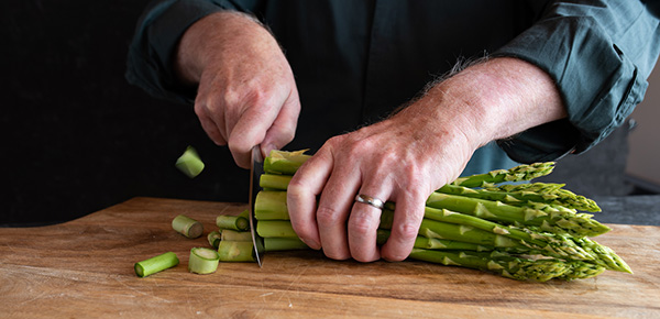 person cutting asparagus