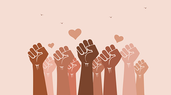 People's fists raised in the air with heart-shaped love symbols. Solidarity, unity, love, diversity and inclusion concept. Teamwork, racial harmony and tolerance.