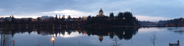 A panorama photo featuring sunset over the Washington State capitol building in Olympia, WA.