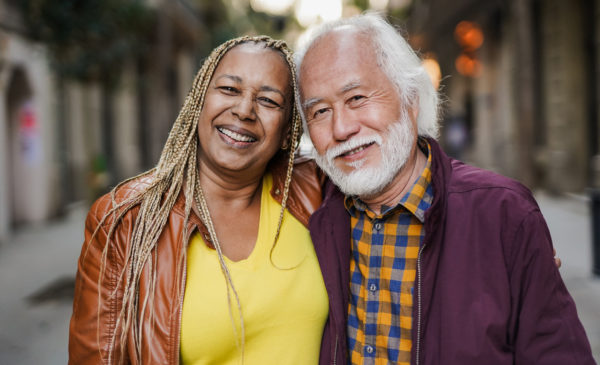 Happy multiethnic senior couple smiling on camera