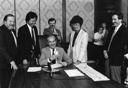 Governor Booth Gardner signed Washington State’s New Car Lemon Law in May 1987. Herb Weisbaum stands at far right.