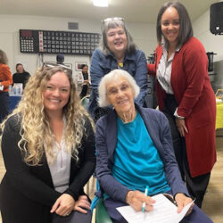 A picture of Kelsey Shultz (left), Mary Pat O’Leary (back), and Deidre Daymon (right) pose with a participant at the September 2023 Civic Coffee.