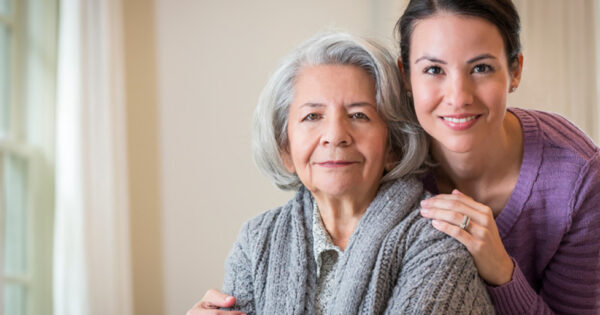 Close up of smiling daughter hugging mother