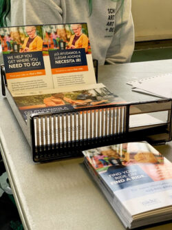 Fina-a-ride brochures pictured stacked on a table.